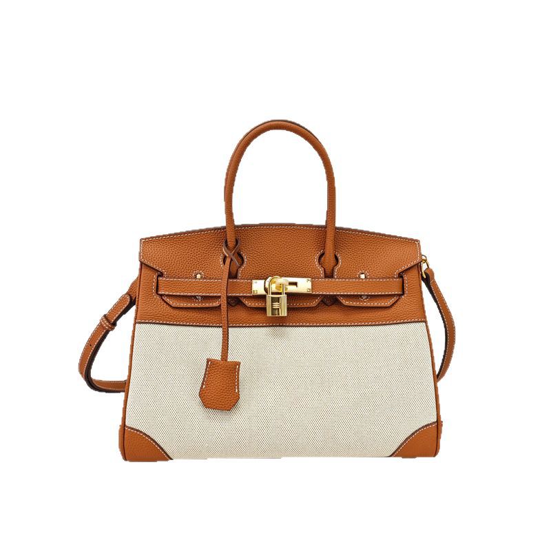 Top Handle Bag in Pebbled Grain Leather & Canvas with Gold-Tone Twist Lock product image 1