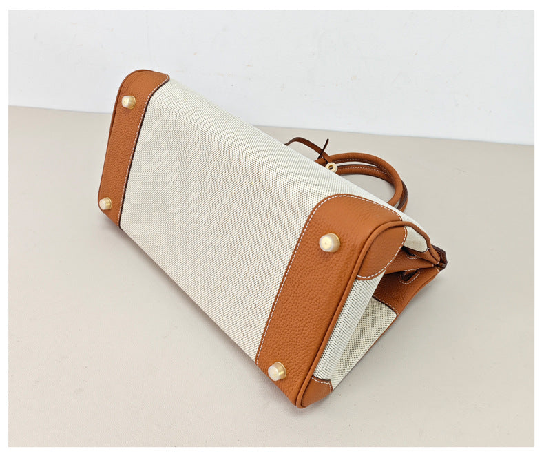 Top Handle Bag in Pebbled Grain Leather & Canvas with Gold-Tone Twist Lock detail image 3